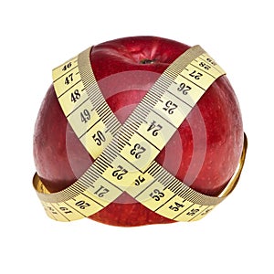 Red apple wrapped with yellow measurement tape.