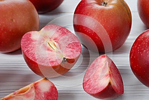 Red apples called Redlove are located on a wooden surface