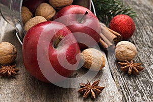 Red apples with christmas spices decoration on woden background