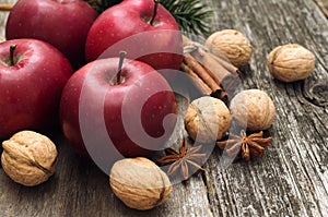 Red apples with christmas spices decoration on woden background