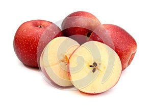 Sliced Red apples with green leaves isolated on white background.