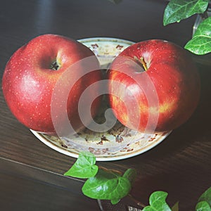 Red apples on a plate. Still life