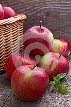 Red apples spill out of the basket