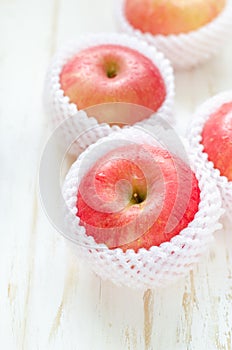 Red Apples on white wooden table