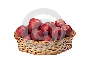 Red apples in wicker basket on isolated white background