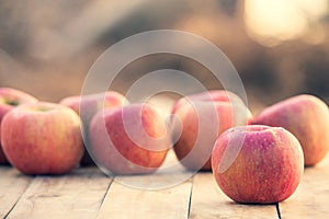 Red apples on wooden table. Copy space