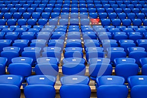 Red armchair in a row of blue armchairs. Be different. Be special.