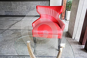 Red armchair and table with glass on top