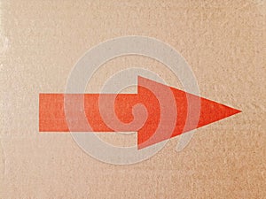 Red arrow on cardboard paper