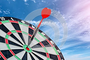 Red arrow Dart hitting the center of dartboard