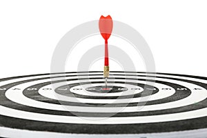 Red arrow hitting target on dart board