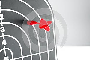 Red arrow shooting at heart position of profile shape black dart