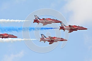 Red Arrows trailing blue and white smoke