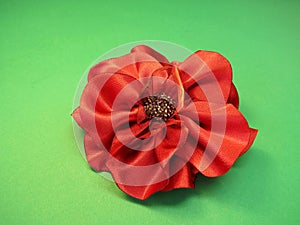 Red artificial fabric flower