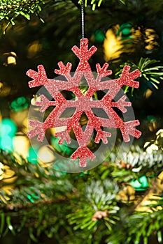 Red artificial snow flake in a christmas tree