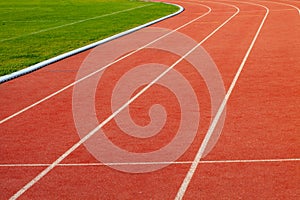 Red athletic running track in stadium. Rubber coating