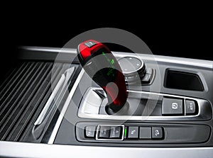 Red Automatic gear stick of a modern car. Modern car interior details. Close up view. Car detailing. Automatic transmission lever