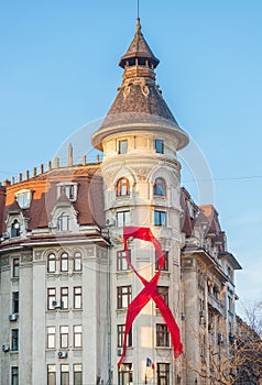 Red awareness ribbon on a Bucharest old building