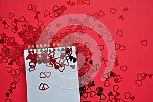 empty notebook between red hearts