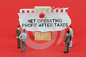 On a red background are miniature figures of people looking at an ad with the inscription Net Operating Profit After Tax