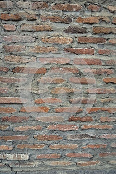 Red background of old vintage brick wall texture. Close up view of old stone brick wall with medieval masonry,