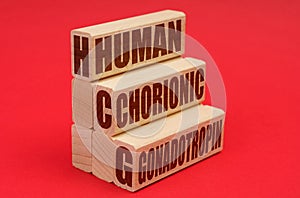 On a red background, wooden blocks with the inscription - human chorionic gonadotropin