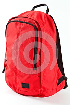 Red backpack with black details isolated on white background.