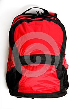 Red backpack with black details isolated on white background.