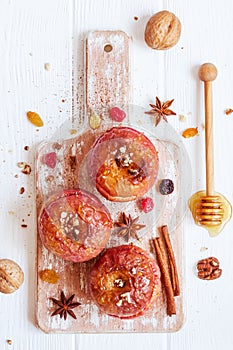 Red baked apples with cinnamon, walnuts and honey. Autumn or win