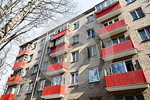 Red balconies on the facade of a residential building