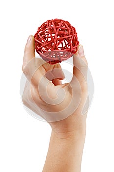 Red ball in the form of a ball in the hand of a man