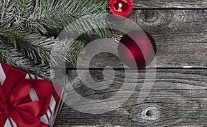 Red ball ornament plus decorations on vintage wooden planks for a merry Christmas or happy New Year holiday celebration concept