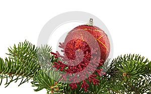 red ball and red snowflake with branch of Christmas tree isolated