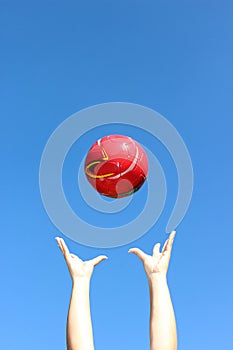 Red ball thrown in the air