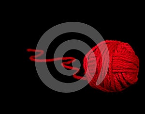 Red ball of yarn on black