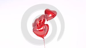 Red balloons in the form of hearts on a white background