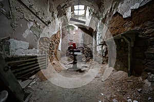 Red barber chair in a jail cell