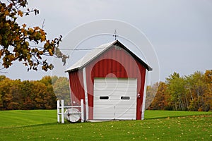 A red barn with the background of fall foliage near Watkins Glen, New York, U.S