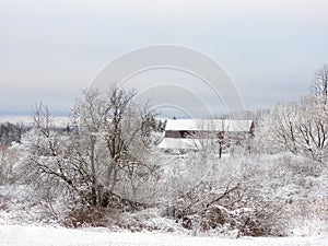 Red barn covered in snow in NYS FingerLakes overlooking CayugaLake