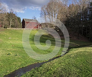 Red Barn on a Hill with Stream