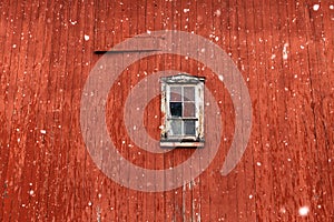 Red barn with snowflakes and a window