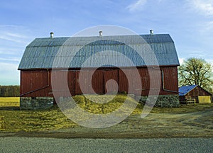 A Red Barn Under A Blue Sky