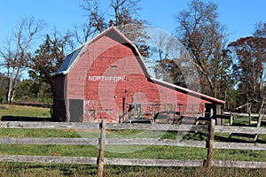 Red Barn with a Weathered Fence
