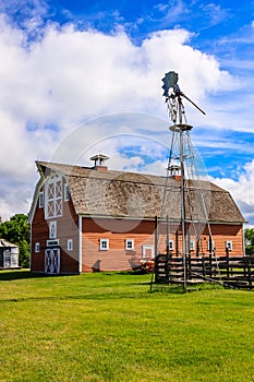 A red barn with a windmill on top