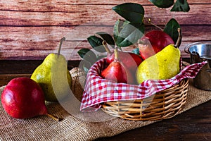 Red battler pears or red pear and packham or green pears in a basket on a table. Organic and natural products