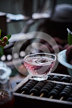 Red bayberry bubble tea on the table(waxberry), in architectural interior with oriental charm, dark environment