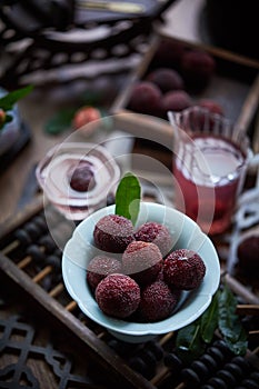 Red bayberry on the table(waxberry), in a building interior with oriental charm, dark environment, dark tone picture