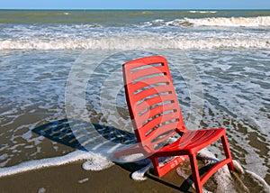 Red beach chair by the ocean