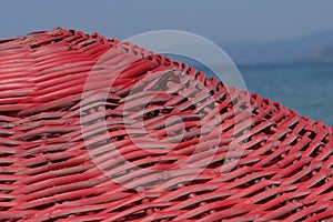 Red beach umbrella on the background of the sea horizon.