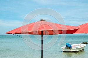 Red beach umbrella at the beach